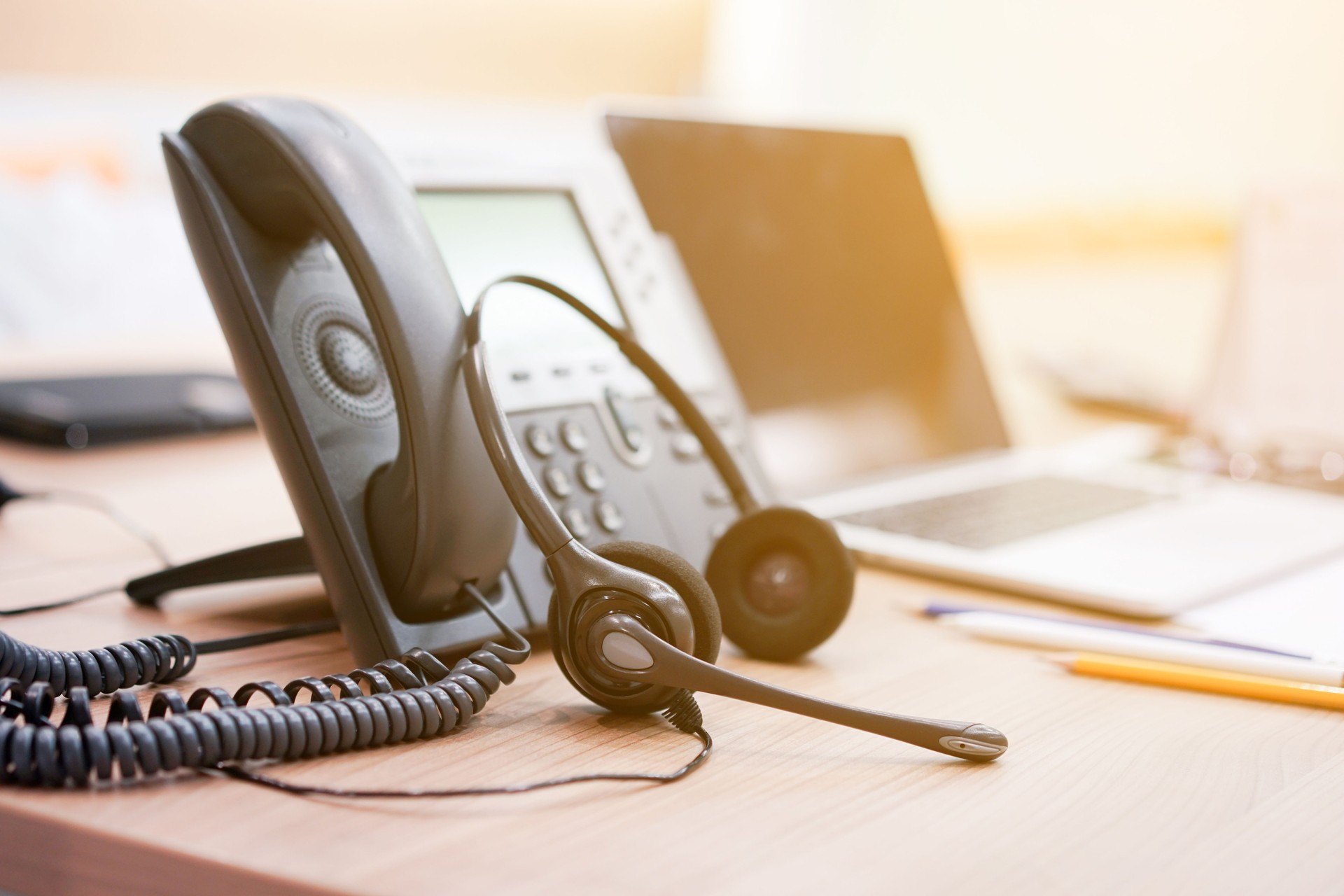 Phone Service telephone VOIP system at office desk for hotline telemarketing concept with vintage color filter